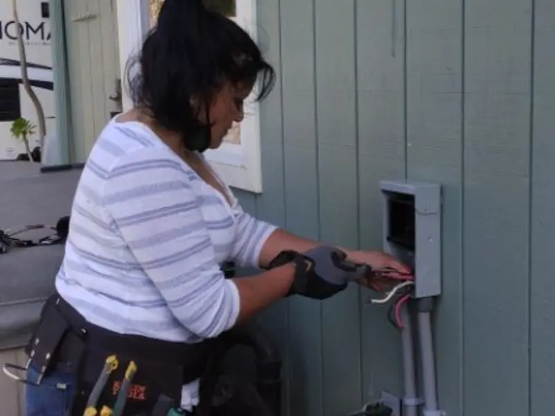 Licensed electrician wiring an exterior subpanel in Portland